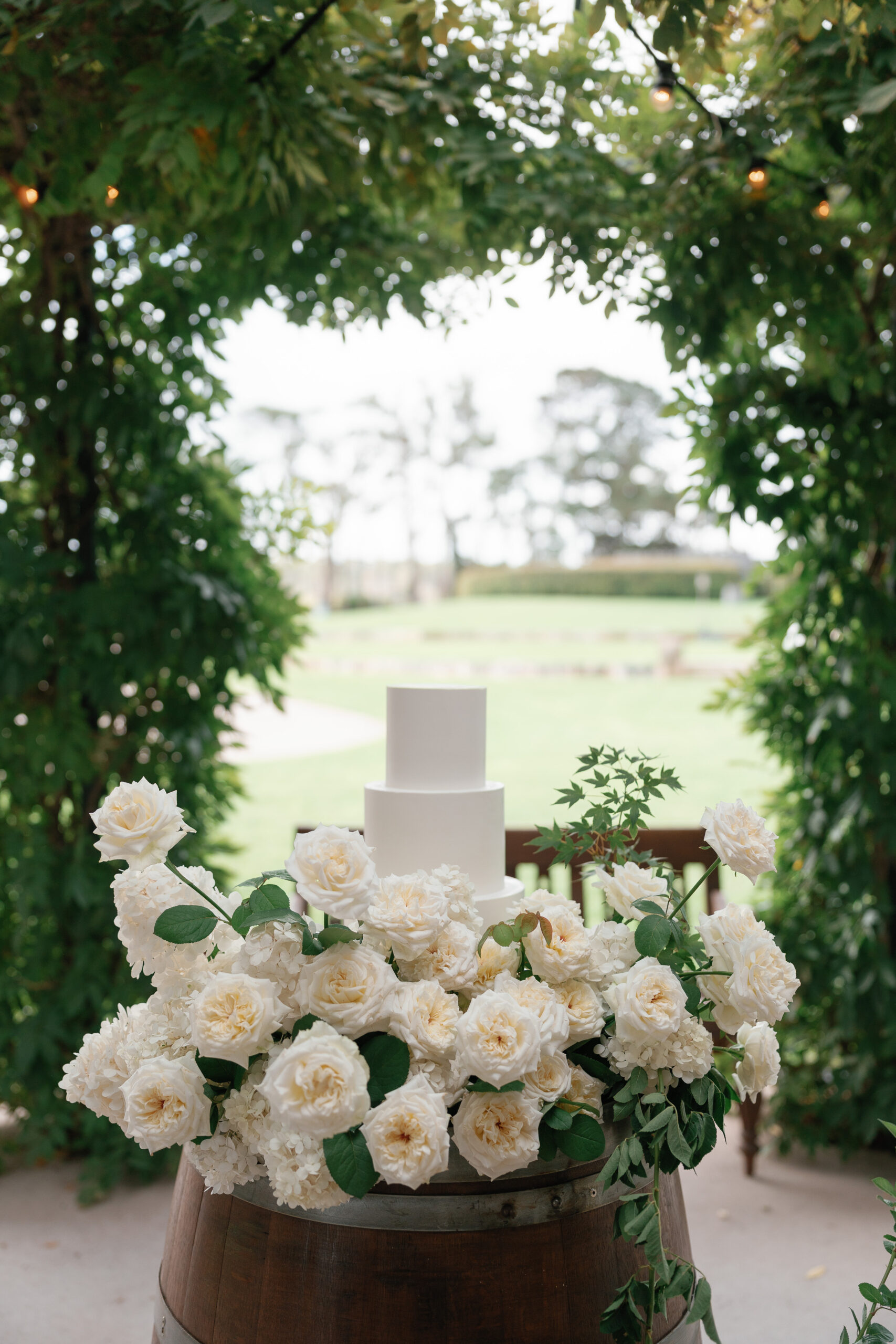 Aisling and Stefan. 3 tier white cake with large flower meadow