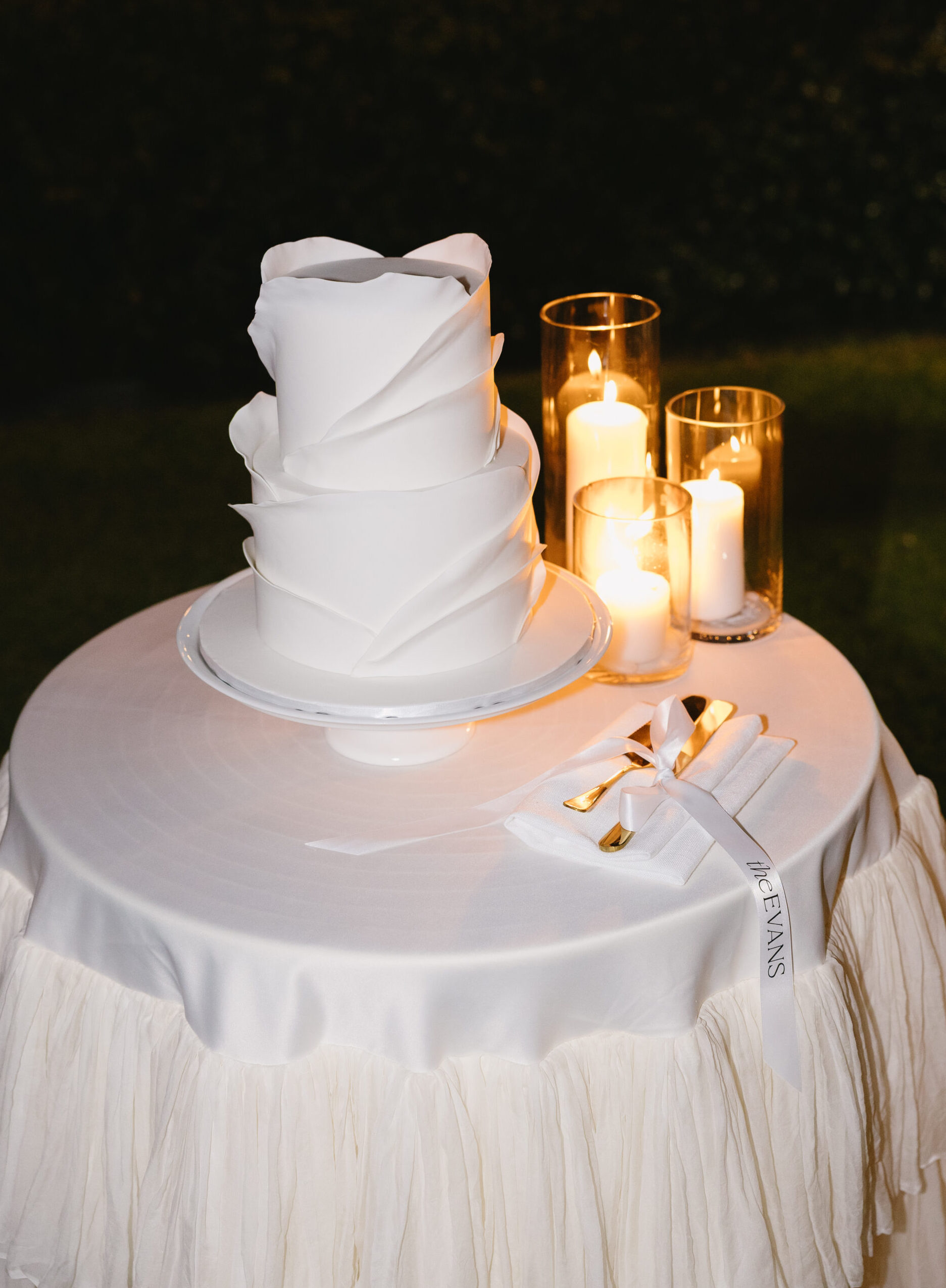 Tow tier fondant cake with modern ruffles. Set up at Squire Vineyard